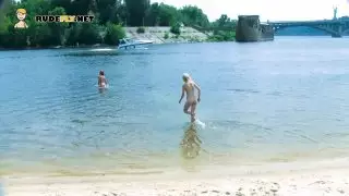 Nudist teens with slim body is enjoying the sun on the rocky beach